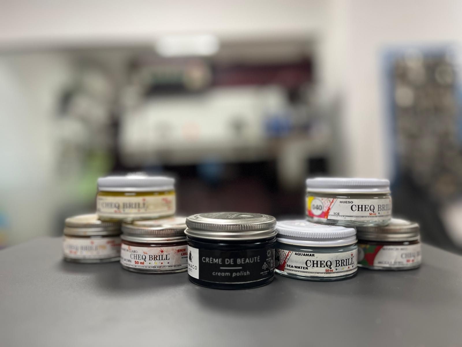 Collection of shoe polish tins arranged on a table.